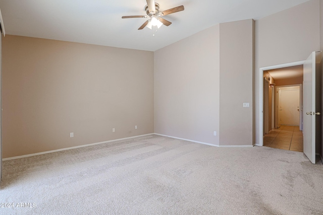 spare room with light carpet and ceiling fan