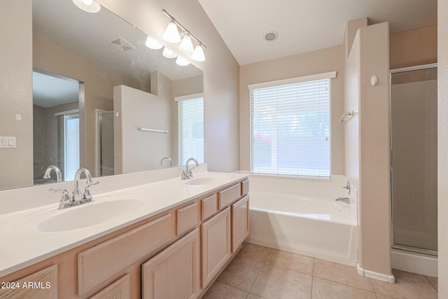 bathroom with tile patterned floors, independent shower and bath, and vaulted ceiling