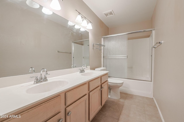 full bathroom featuring toilet, tile patterned flooring, vanity, and combined bath / shower with glass door