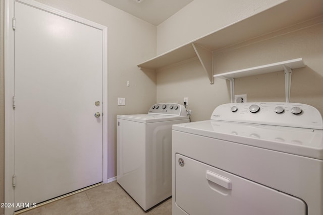 7275 W Tina Ln, Glendale, AZ 85310 - laundry area with washer and clothes dryer and light tile patterned flooring