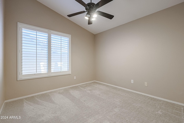 empty room with ceiling fan, light colored carpet, and lofted ceiling