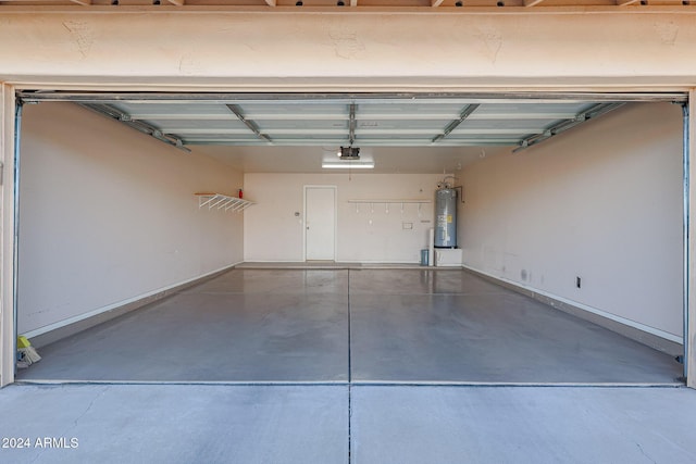 garage featuring electric water heater and a garage door opener