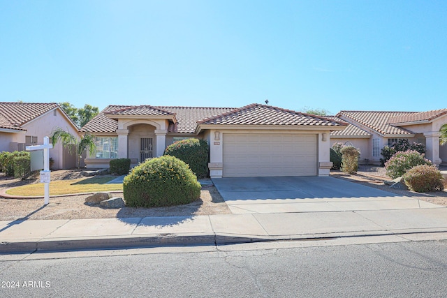 7275 W Tina Ln, Glendale, AZ 85310 - mediterranean / spanish home with stucco siding, an attached garage, driveway, and a tile roof