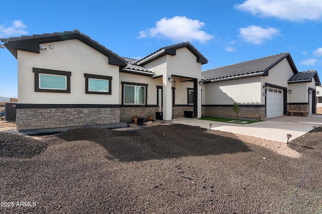 view of front of property featuring cooling unit and a garage