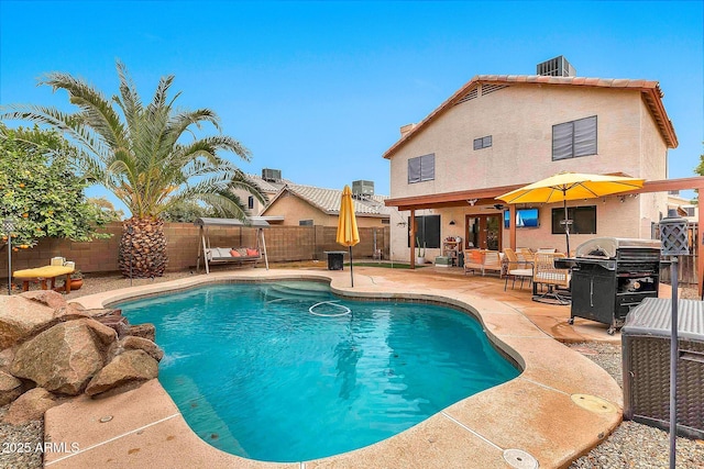 view of swimming pool featuring grilling area and a patio