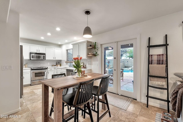 dining room featuring sink and french doors