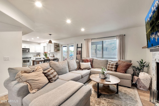 living room with a stone fireplace