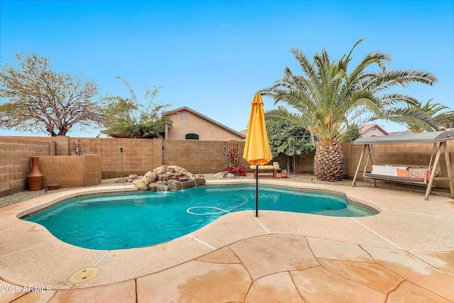 view of pool with a patio and pool water feature