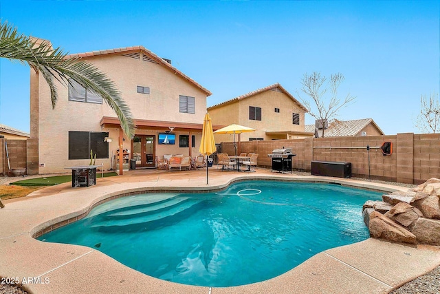 view of pool with a grill and a patio area