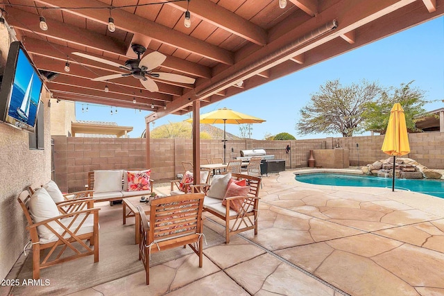 view of patio with an outdoor living space, a fenced in pool, pool water feature, and ceiling fan