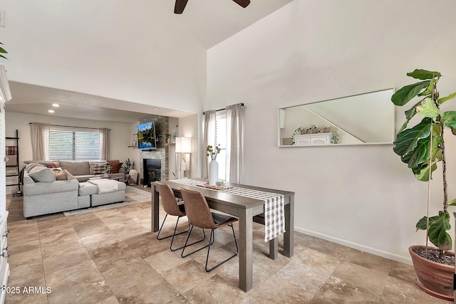 dining area with a high ceiling and ceiling fan