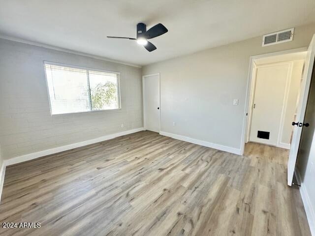 unfurnished bedroom with ceiling fan and light hardwood / wood-style floors