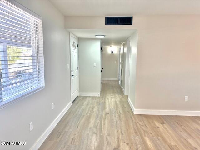 hall with light hardwood / wood-style floors