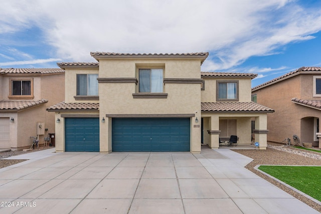 mediterranean / spanish-style home with a garage