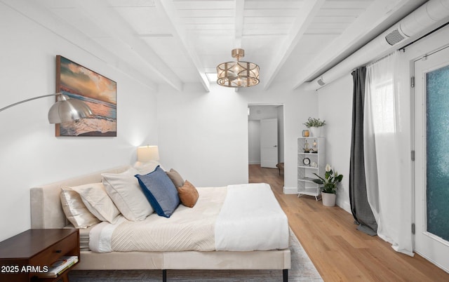 5809 N 10th Pl, Phoenix, AZ 85014 - bedroom featuring light wood-type flooring, an inviting chandelier, and beam ceiling