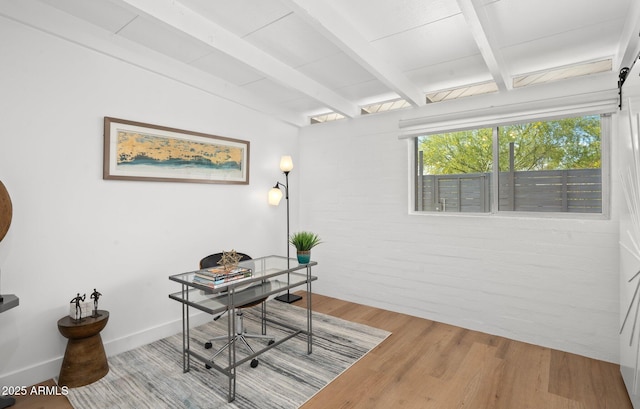 5809 N 10th Pl, Phoenix, AZ 85014 - home office featuring beam ceiling, brick wall, wood finished floors, and baseboards