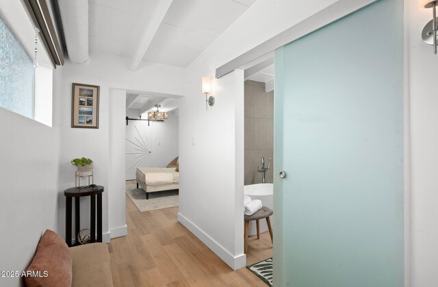 5809 N 10th Pl, Phoenix, AZ 85014 - hallway featuring light wood finished floors and beamed ceiling