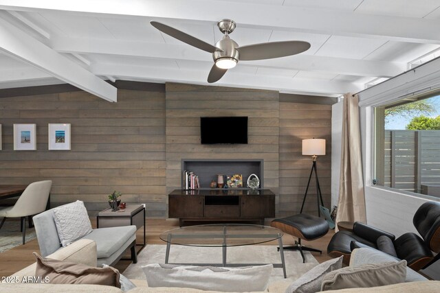 5809 N 10th Pl, Phoenix, AZ 85014 - living room featuring wood finished floors, wooden walls, ceiling fan, and vaulted ceiling with beams
