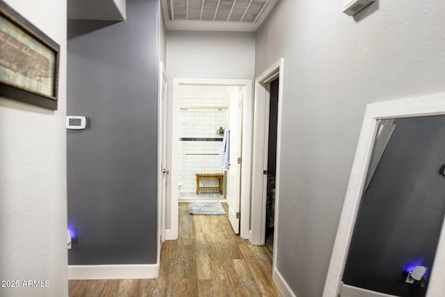 corridor with hardwood / wood-style floors