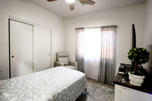 bedroom with ceiling fan and a closet