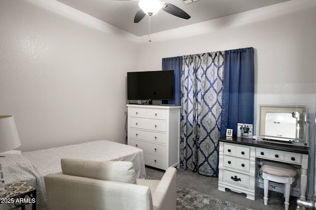 bedroom featuring ceiling fan and dark colored carpet