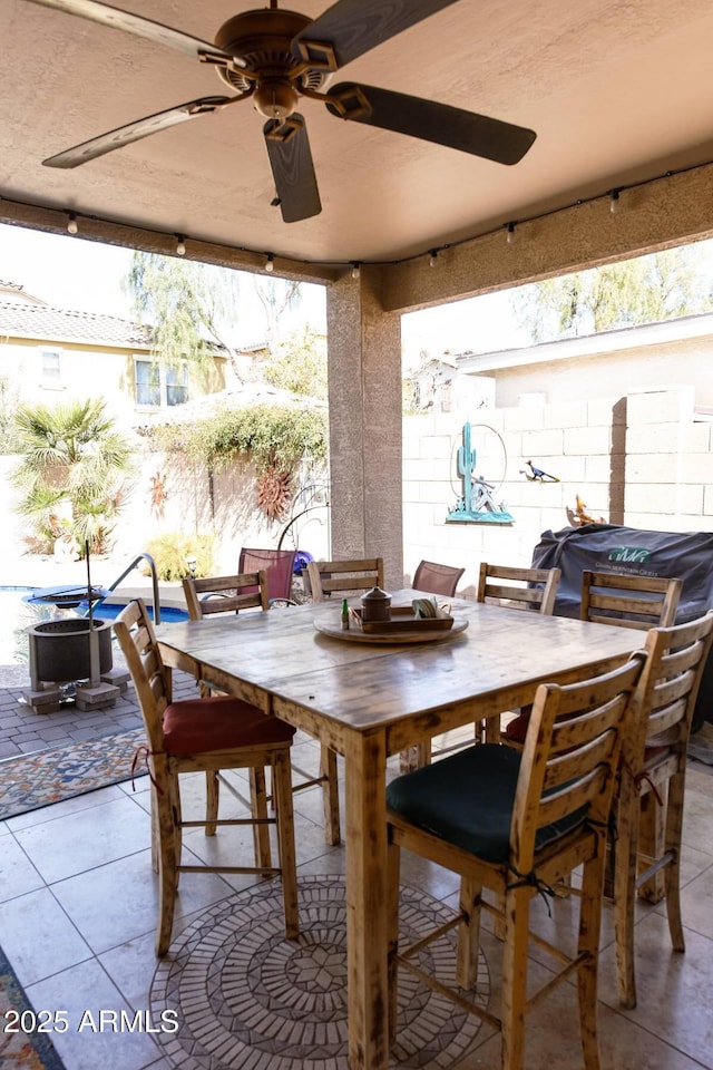 dining space featuring tile patterned flooring and ceiling fan