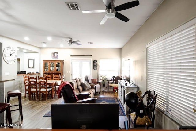 living room featuring hardwood / wood-style floors and ceiling fan