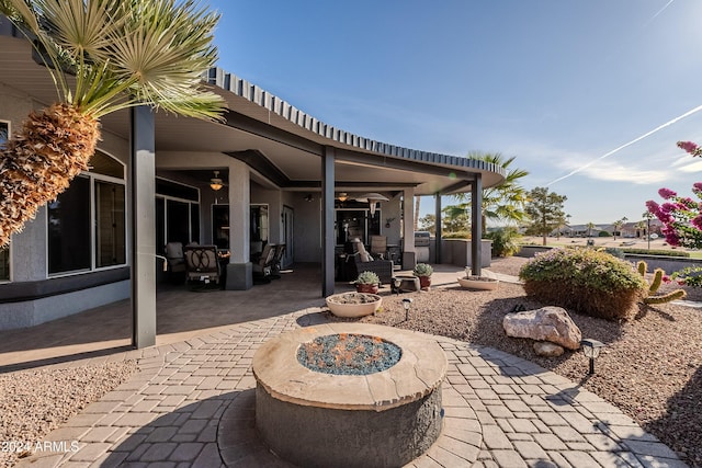 view of patio / terrace featuring an outdoor living space with a fire pit