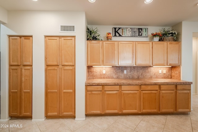 kitchen with backsplash, light brown cabinets, and light tile patterned floors