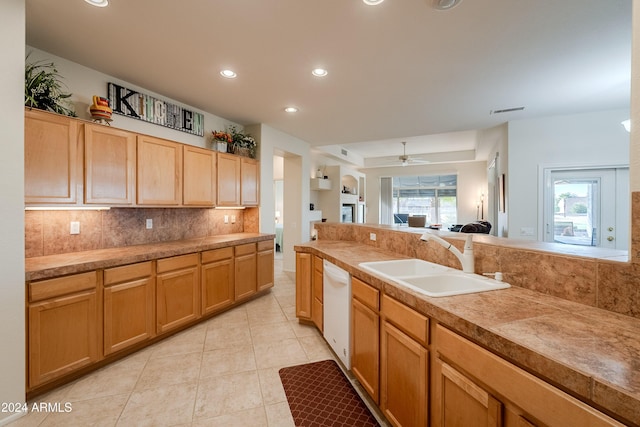 kitchen featuring decorative backsplash, ceiling fan, a wealth of natural light, and sink