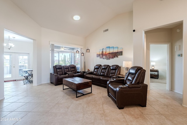 living room with plenty of natural light, light tile patterned floors, and ceiling fan with notable chandelier