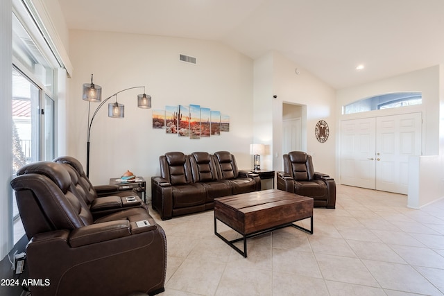 living room featuring light tile patterned flooring and lofted ceiling