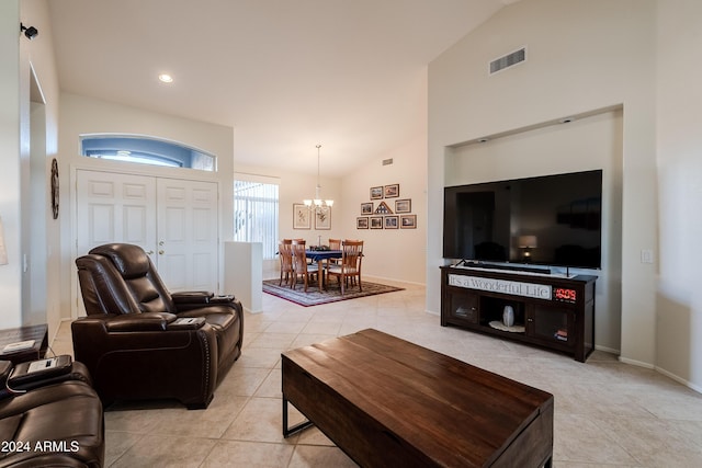 tiled living room with a chandelier and lofted ceiling