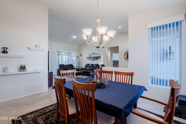 tiled dining space with an inviting chandelier