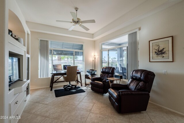 home office with light tile patterned floors and ceiling fan