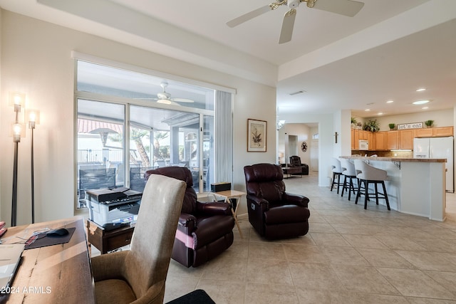 living room featuring ceiling fan and light tile patterned floors