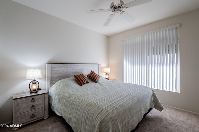 bedroom with ceiling fan and dark colored carpet