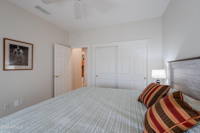 bedroom with ceiling fan and a closet