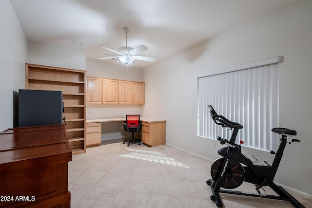 home office featuring ceiling fan and built in desk