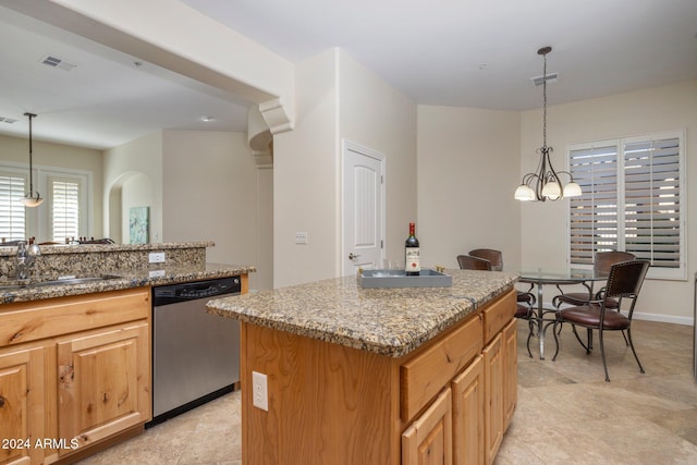 kitchen with dishwasher, a kitchen island, sink, and decorative light fixtures