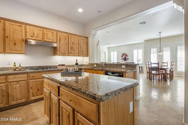 kitchen with black dishwasher, kitchen peninsula, pendant lighting, stainless steel gas stovetop, and a kitchen island