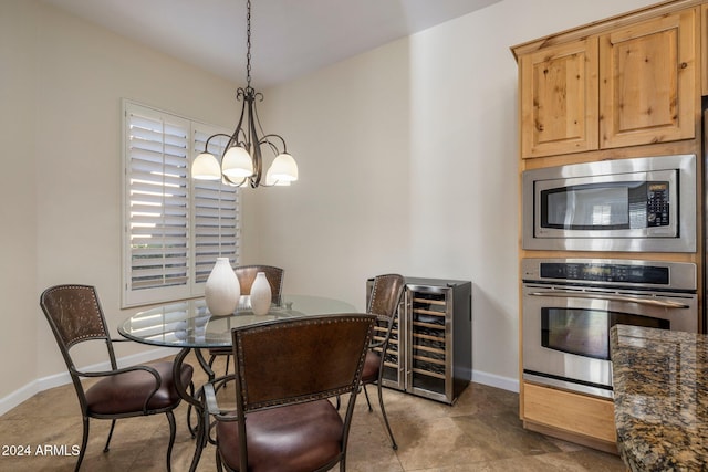 dining space featuring an inviting chandelier and beverage cooler