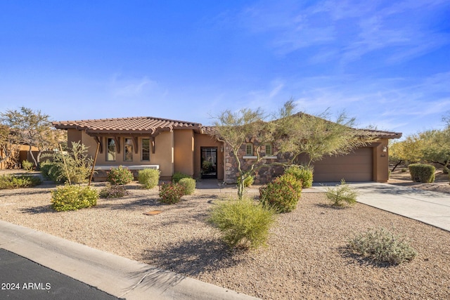 mediterranean / spanish-style home featuring a garage