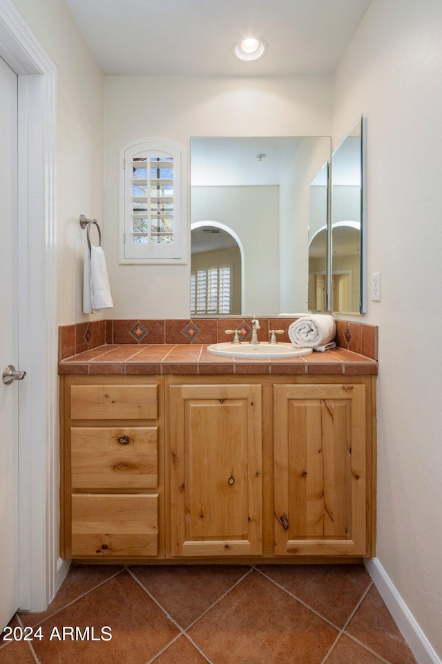 bathroom featuring tile patterned flooring and vanity