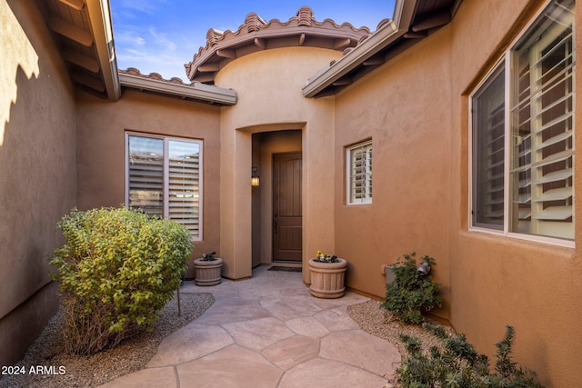 property entrance with a patio area