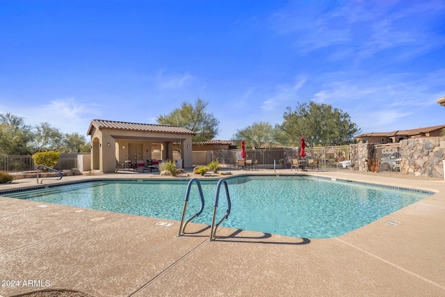 view of pool with a patio area and an outdoor structure