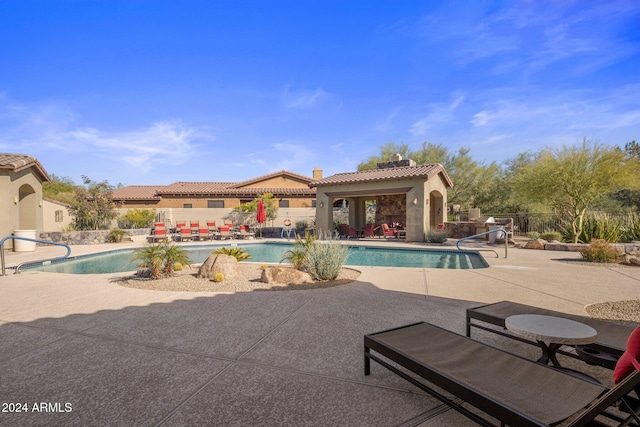 view of swimming pool featuring a patio area