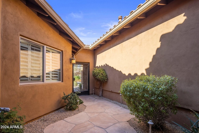 view of exterior entry featuring a patio