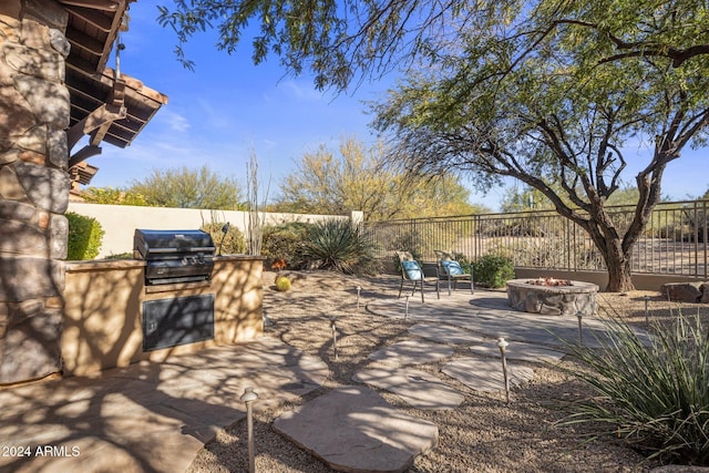 view of patio featuring a fire pit, area for grilling, and grilling area