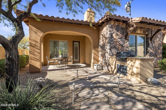 back of house featuring exterior kitchen and a patio